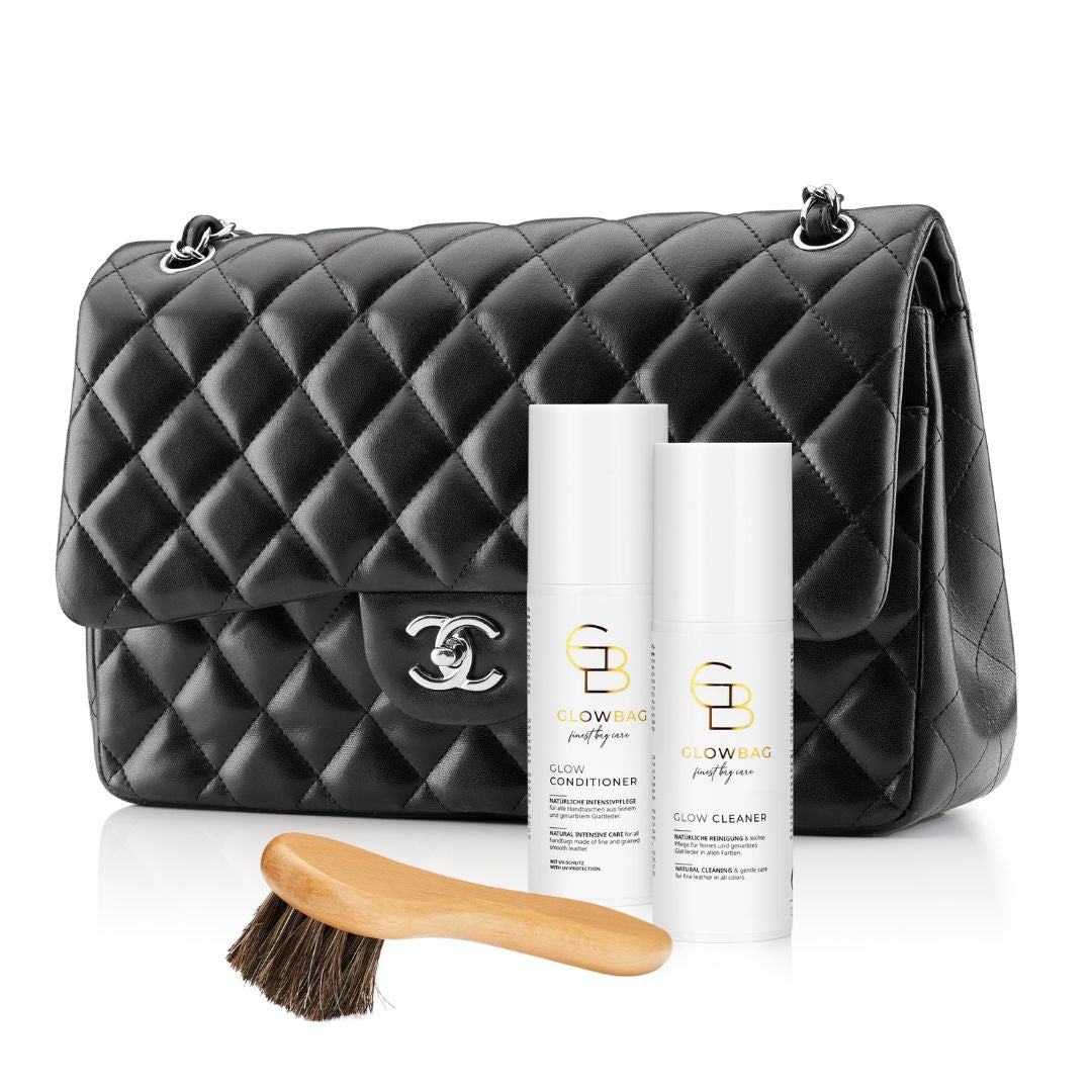 Glow Cleaner und Glow Conditioner mit Lederpflegebürste und Chanel Flapbag im Hintergrund